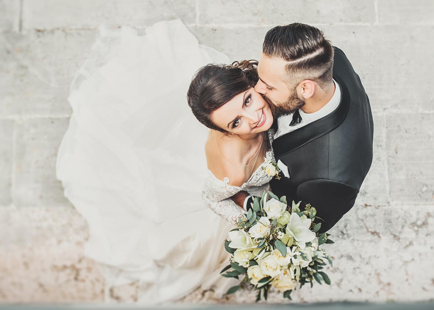 groom kissing his brides cheek