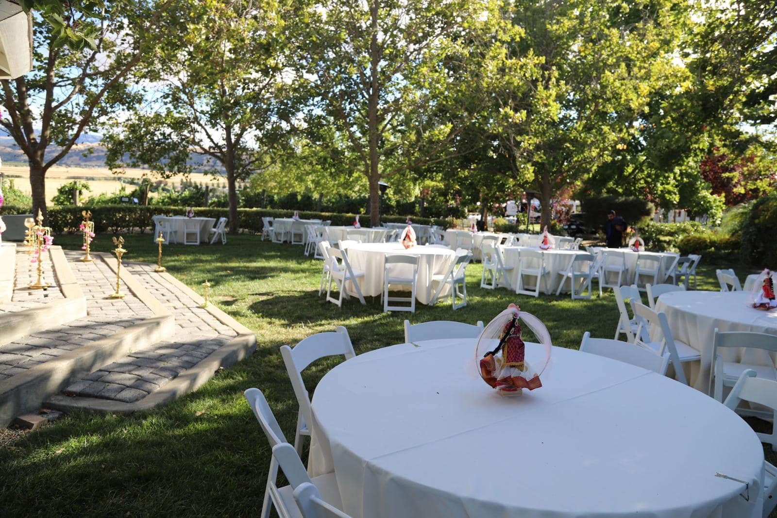 Large outdoor custom event back drop in a gazebo and tables with Mellow Events