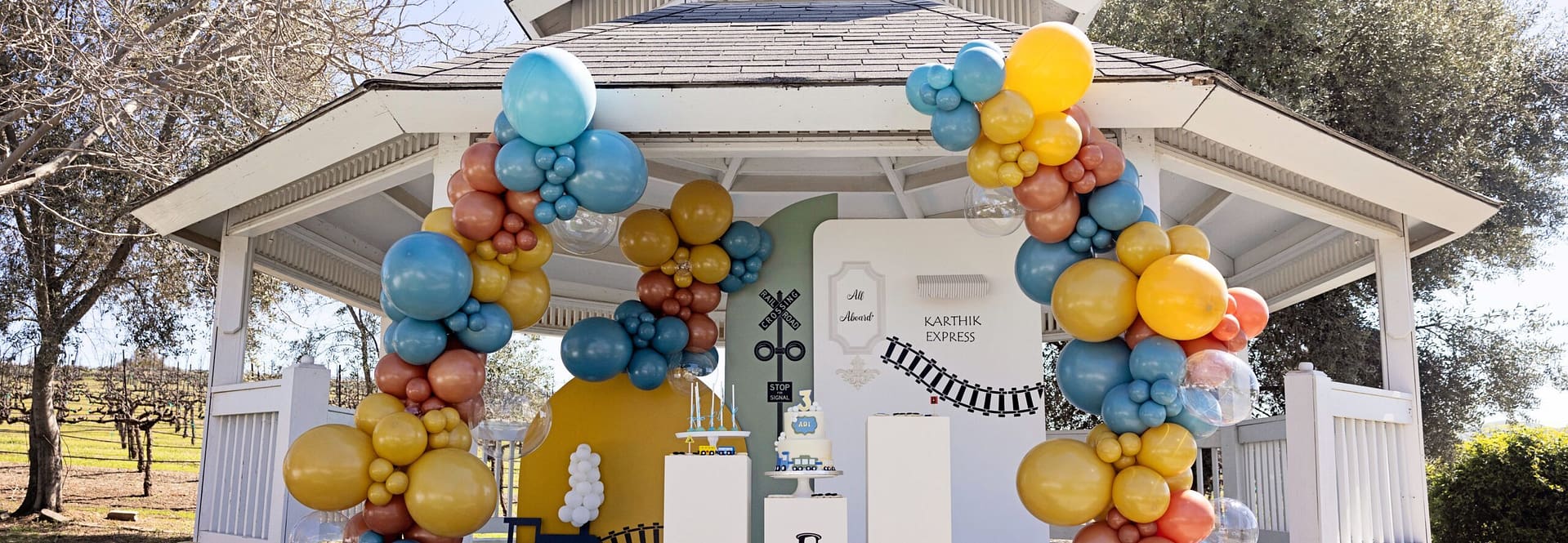 Railroad themed Party with white jump house and lots of balloons by Mellow Events.